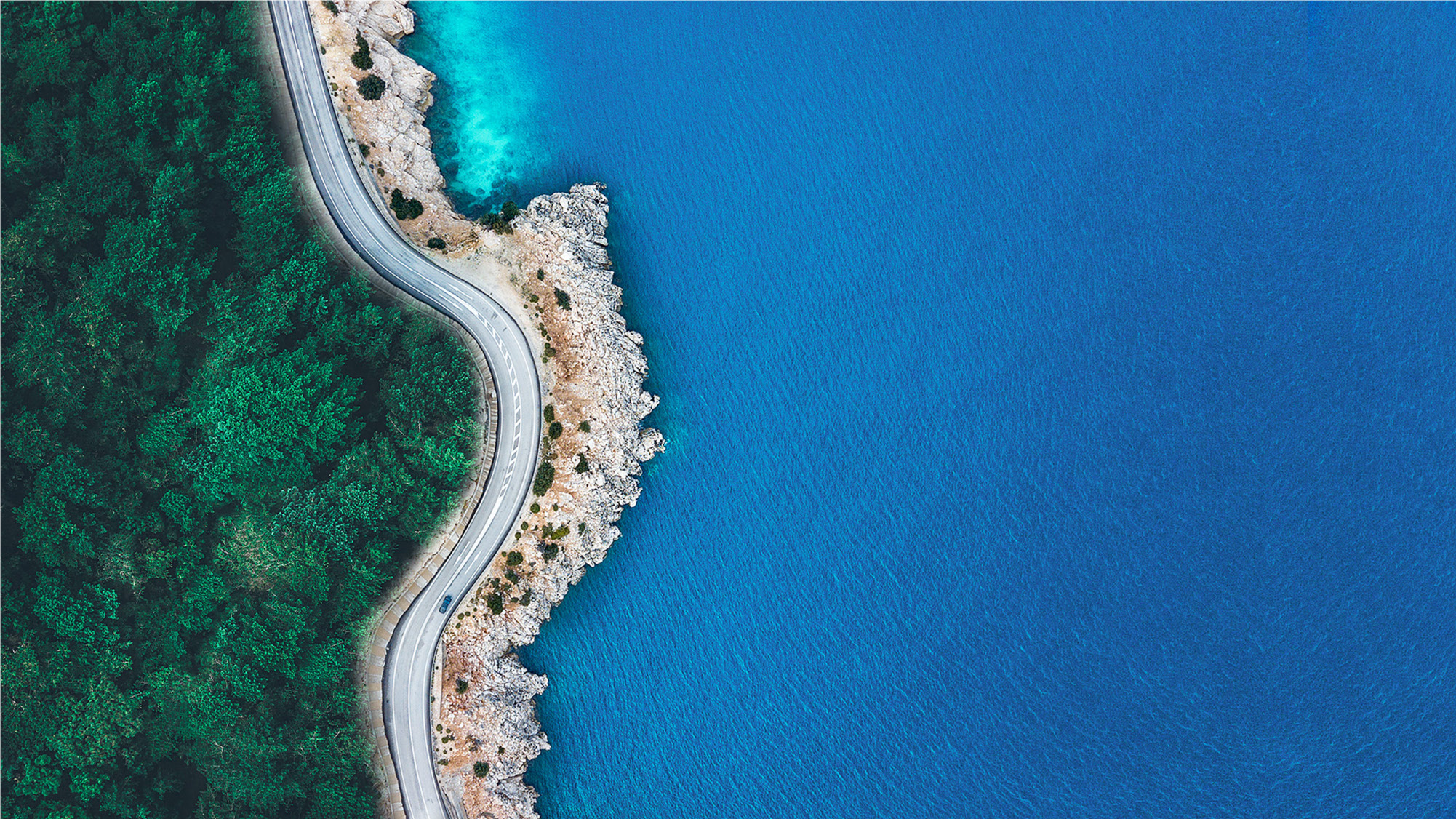 Aerial view of Hainan's coastal highway and blue sea